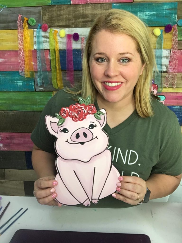 Tamara holding Painted Floral Piggy Door Hanger