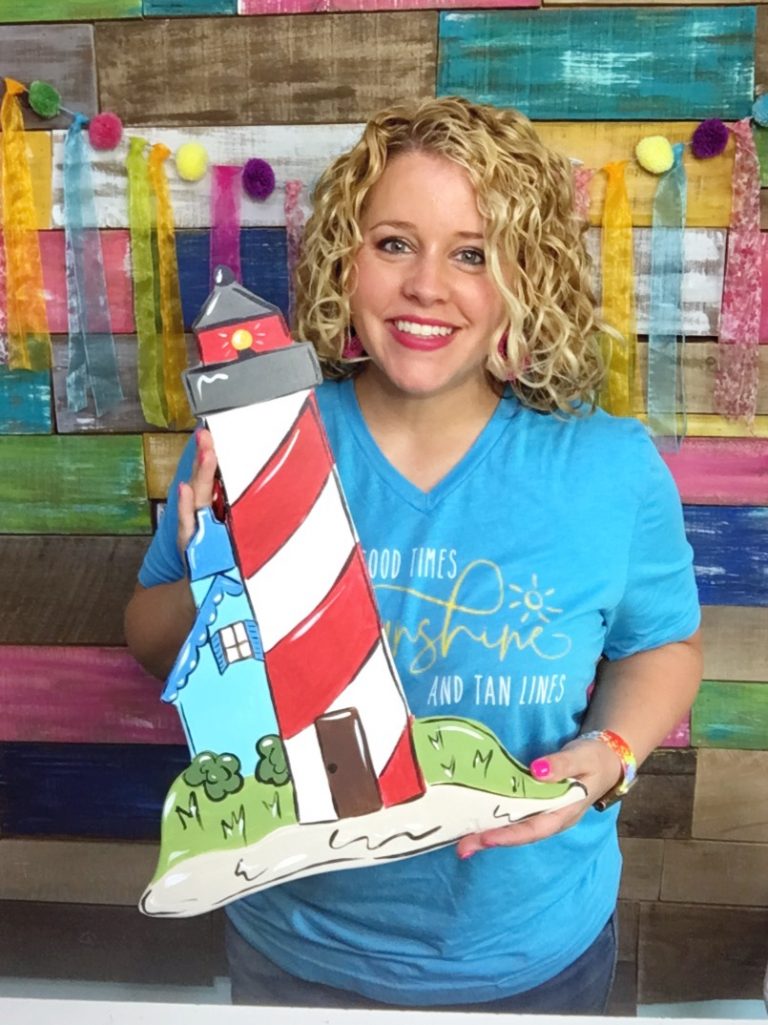 Tamara holding painted Lighthouse Summer Door Hanger