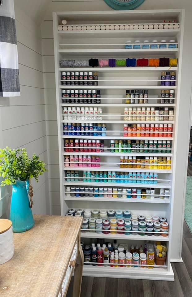 shelf displaying paint bottles