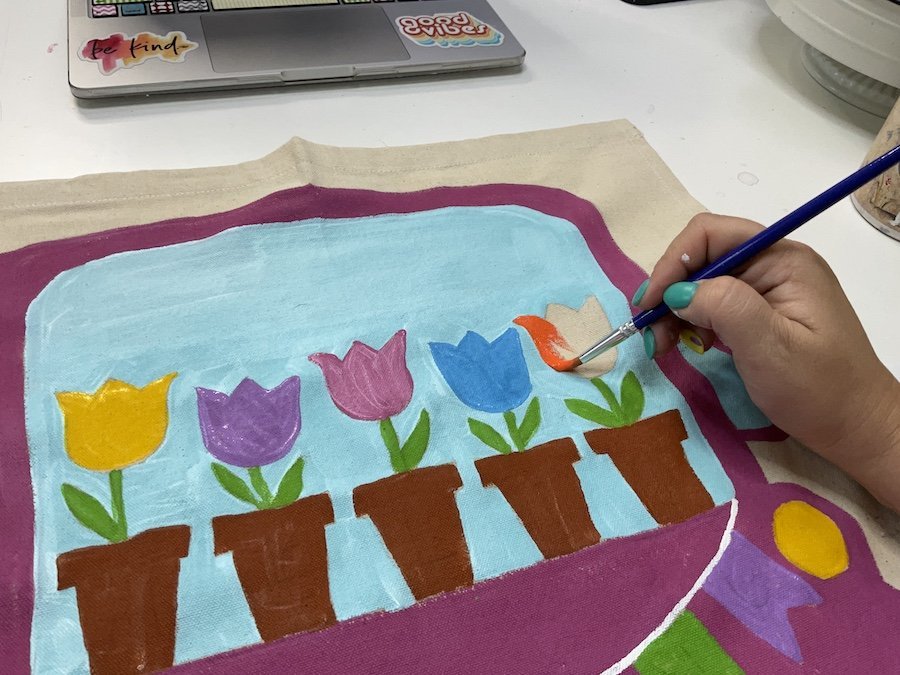 painting the flowers on the spring truck garden flag
