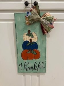 Pumpkin Trio design on a rectangle door hanget that reads thankful