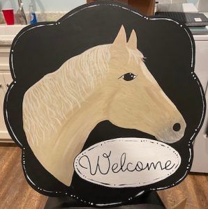 Horse with circle that reads "Welcome"