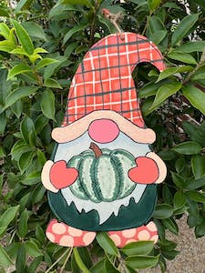 gnome holding a pumpkin door hanger