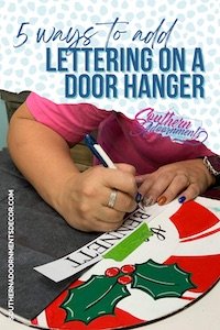 Tamara adding hand lettering to a door hanger with wording that says "Add Hand Lettering on a Door Hanger"