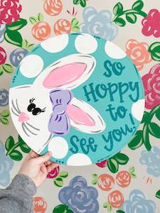 teal door hanger with bunny that says "so hoppy to see you"