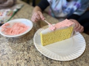 butterknife being used to add icing to the fake cake